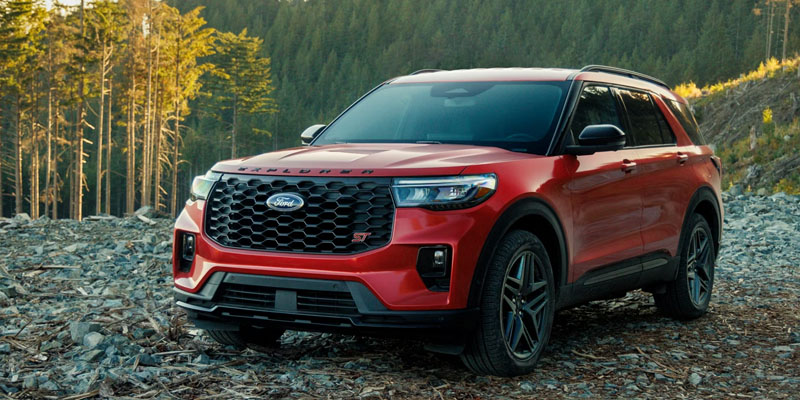 2026 Red Ford Explorer stopped by in mountains showing its front profile