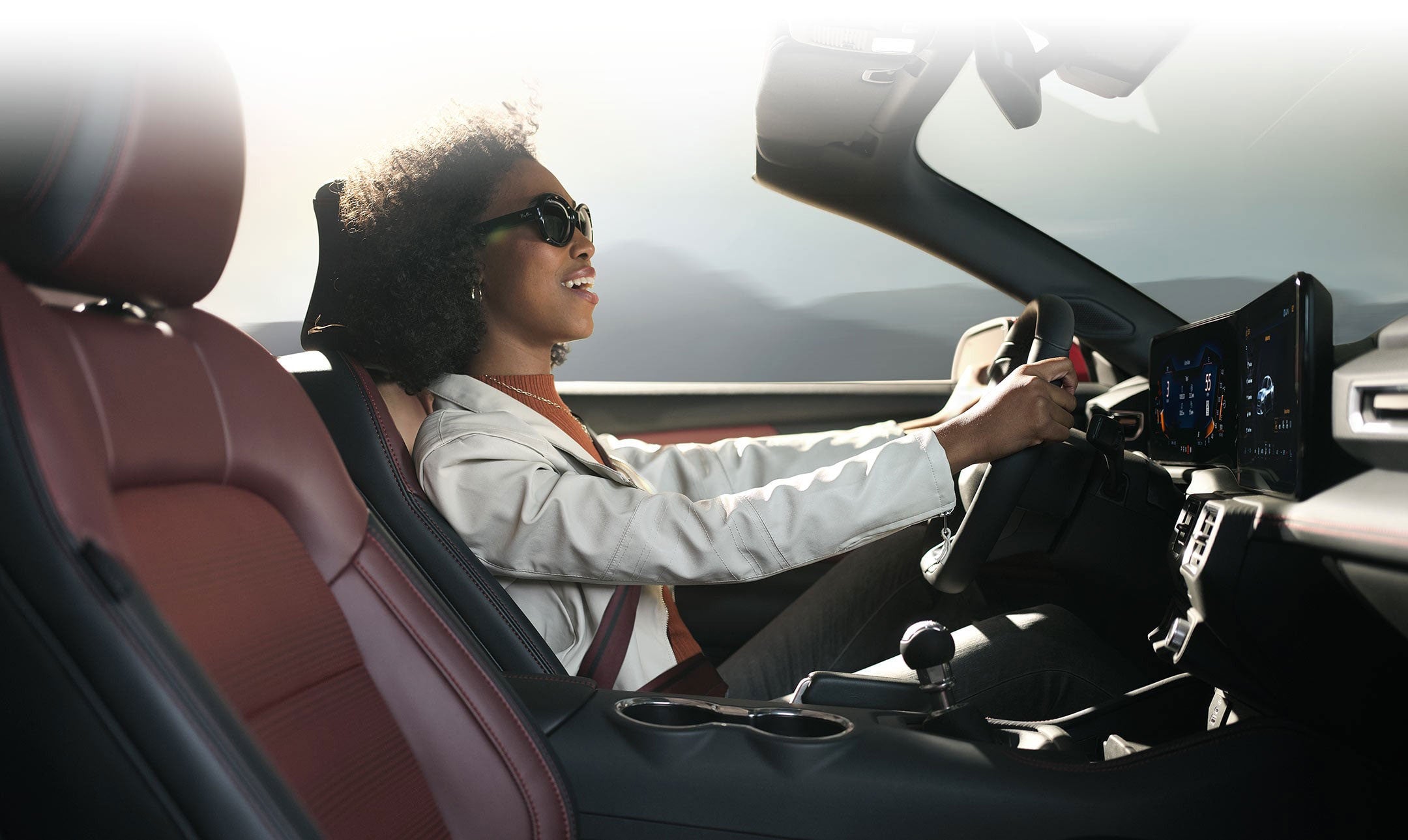 Person sitting in the driver’s seat of a 2024 Ford Mustang® convertible | Midland Ford in Midland MI