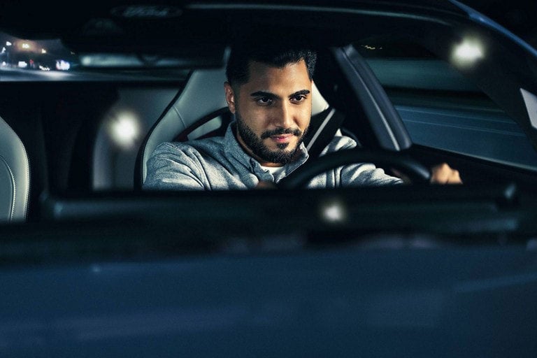 Person sitting in the driver’s seat of a parked 2024 Ford Mustang® coupe | Midland Ford in Midland MI